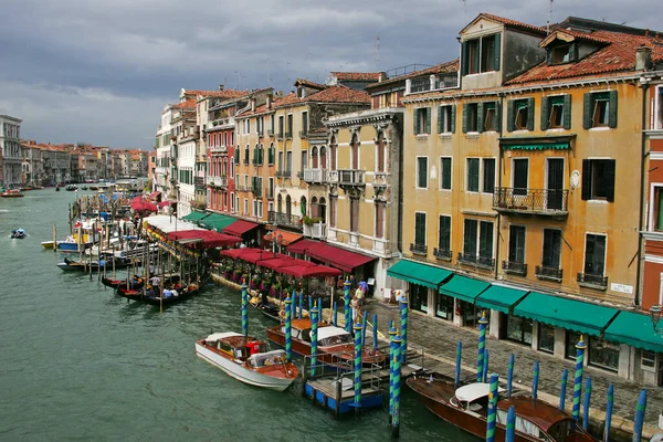Facades of old buildings in Venice with restaurants and gondolas