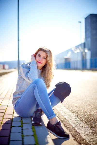 Girl Cap Long Blonde Hair Wearing Jeans Sneakers Sweatshirt Sitting — Stock Photo, Image