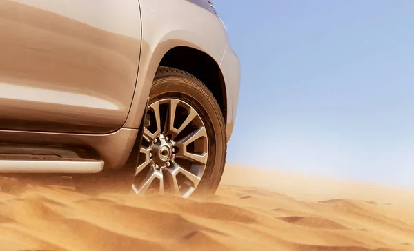 Close up of a golden car stuck in the sand in the Namib desert. Africa