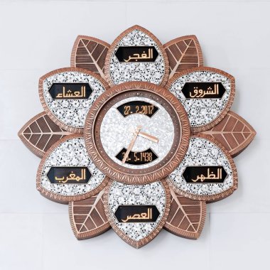 Unique flower shaped clock showing prayer times for Muslims people  hangs on the white marble wall of Grand White Mosque Sultan Sheikh Al Zayed in Abu Dhabi, UAE. Feb.2017 clipart