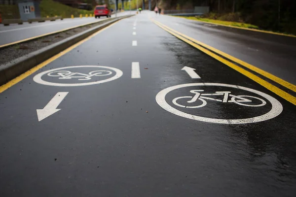 Sign of bicycle lane on asphalt road