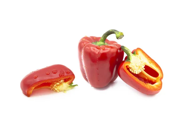 stock image Ripe fresh organic bell pepper, half and a quarter bell peppers in dew drops, isolated on a white background