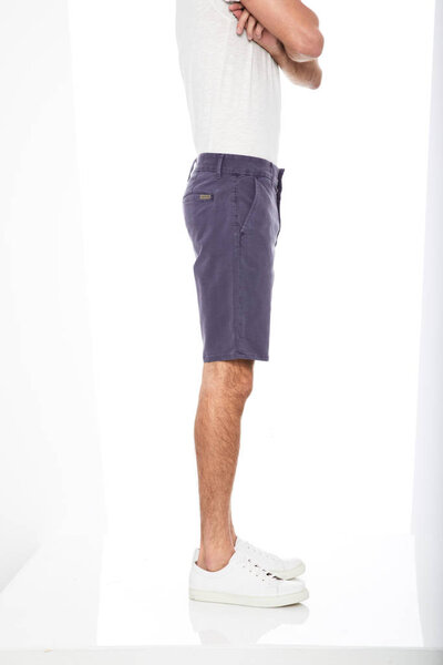 Plain white casual T-shirt carried along blue denim shorts and white sneakers with white background