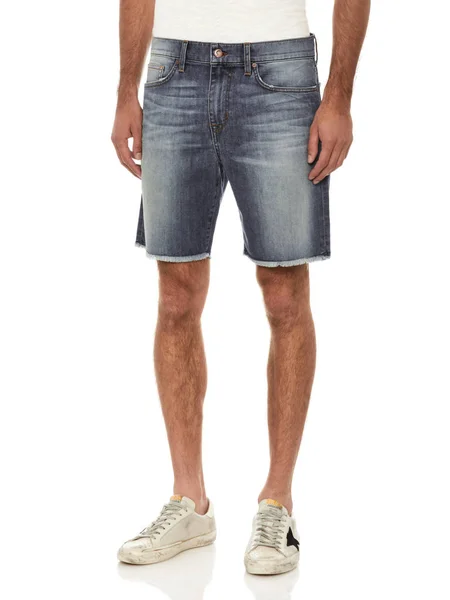 Plain white casual T-shirt carried along blue denim shorts and white sneakers with white background, Blue denim ripped shorts for men’s paired with white tank top and black footwear with white backgro — Φωτογραφία Αρχείου