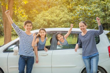 Asya ailesiyle mutlu: mini van gülümseyerek ve yaz seyahat için hazırlanıyor