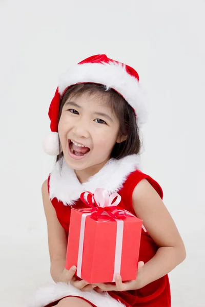 Portrait of happy little Asian girl in red Santa dress — Stock Photo, Image