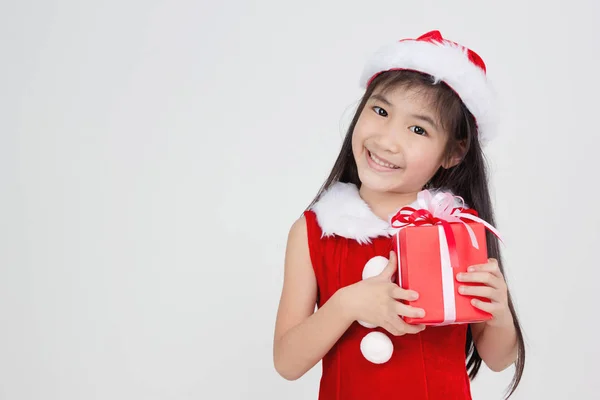 Portrait of happy little Asian girl in red Santa dress — Stock Photo, Image