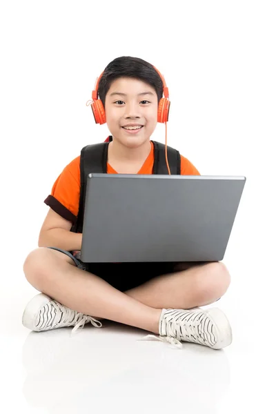 Happy asian boy using laptop . — Stock Photo, Image