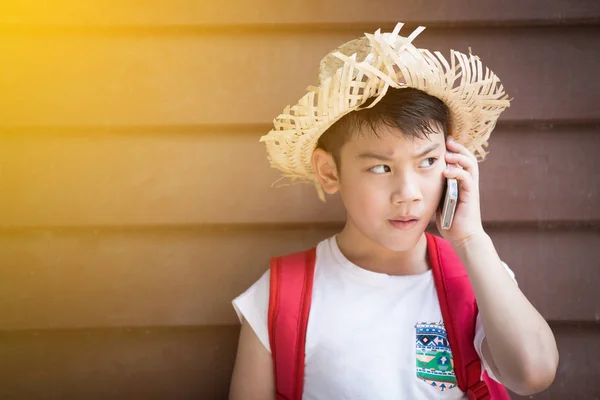 Asian boy speaks by phone — Stock Photo, Image