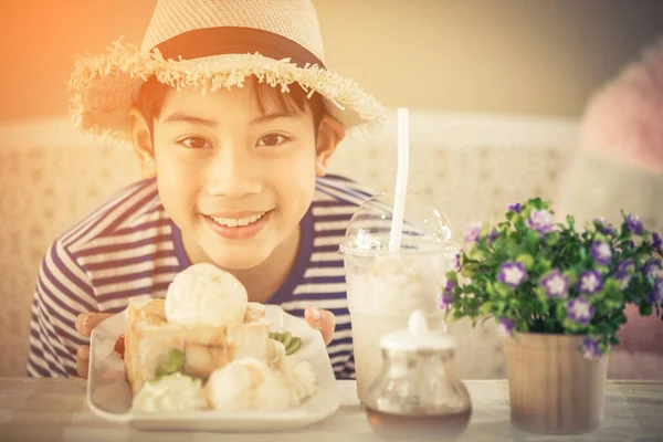 Asian Cute boy enjoying sweet food. — Stock Photo, Image