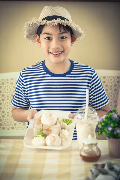 Asian Cute boy enjoying sweet food. — Stock Photo, Image