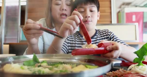 Happy asian family mother and son enjoy eating — Stock Video