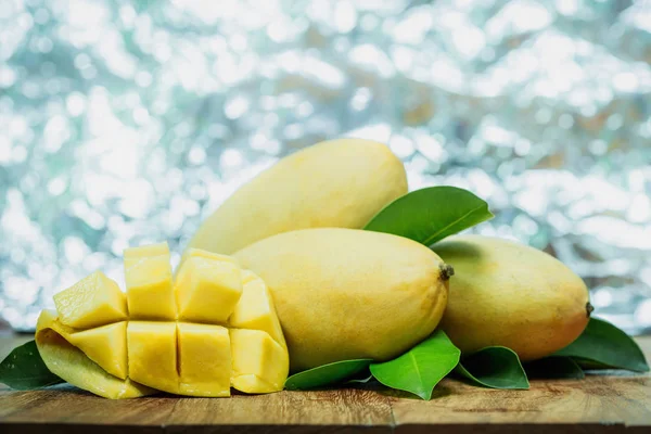 Mango on a dark wood background. tinting. — Stock Photo, Image