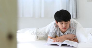 Asya sevimli çocuk dinlenme yatağı ve son test evde önce bir kitap okuma .