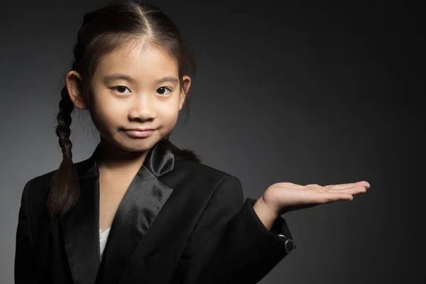 Little asian cute girl is keeping hands spread showing balance — Stock Photo, Image