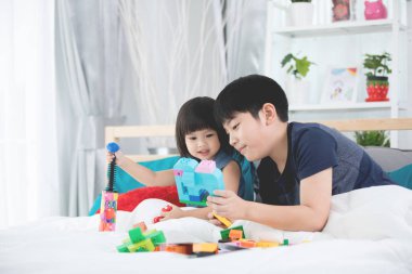 Asyalı çocuklar kardeşleri ve constructo oynayan kız