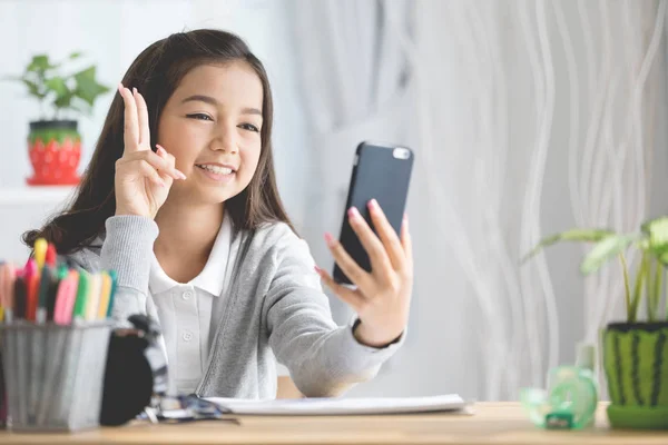 Portrait of a smiling girl pointing finger and take a photo by m — Stock Photo, Image