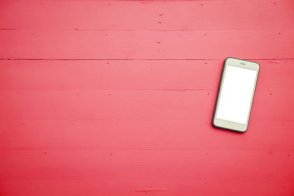 Mobiltelefon med hvid skærm mock op på træ bord baggrund - Stock-foto