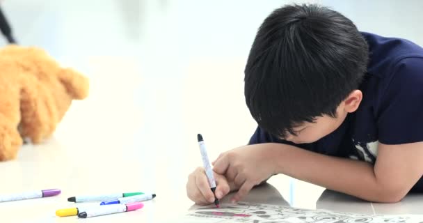 Азиатский Мальчик Отдыхает Полу Рисует Цветной Ручкой — стоковое видео