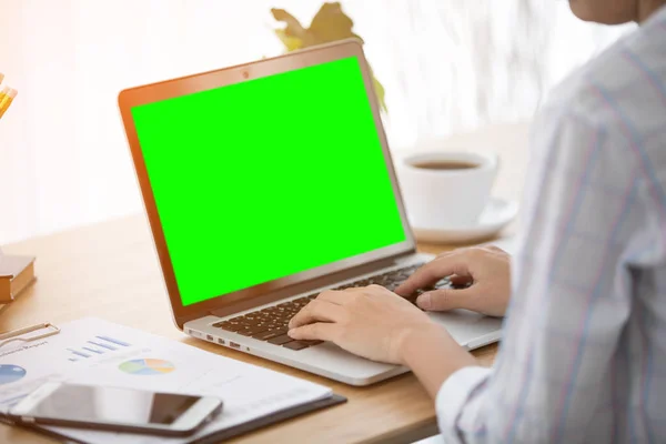 Cheerful business lady working on laptop comouter at home .