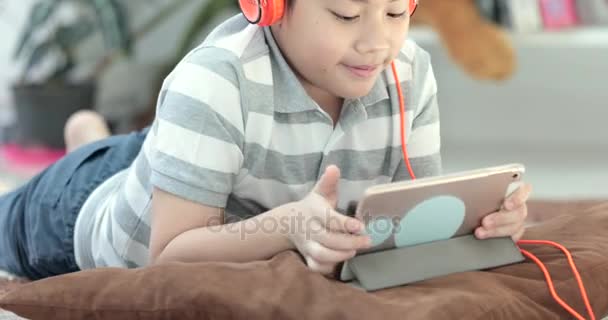 亚洲前青少年休息在地板上 在家里玩平板电脑面带微笑的脸 — 图库视频影像