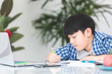 Asya şirin küçük çocuk ciddi bir yüz ile kitap okuma .