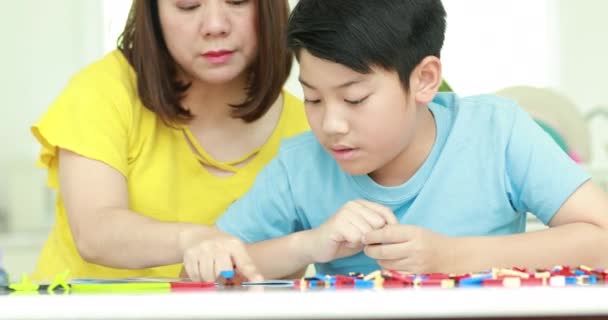 Happy Asian Family Mother Son Playing Plastic Block Together — Stock Video