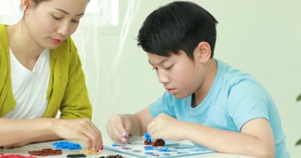 Happy Asian Family Mother Son Playing Plastic Block Together — Stock Video