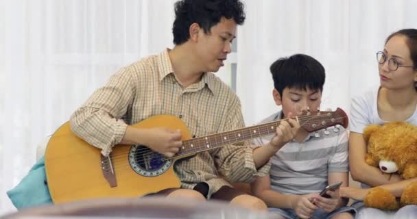 Happy Asian Father Playing Guitar His Family Home — Stock Video