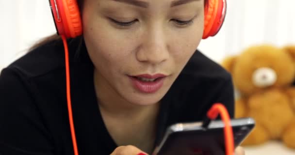 Beautiful Asian Woman Listening Music Earphones Using Smartphone Couch Home — Stock Video