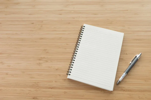 Blank notebook on desk background.