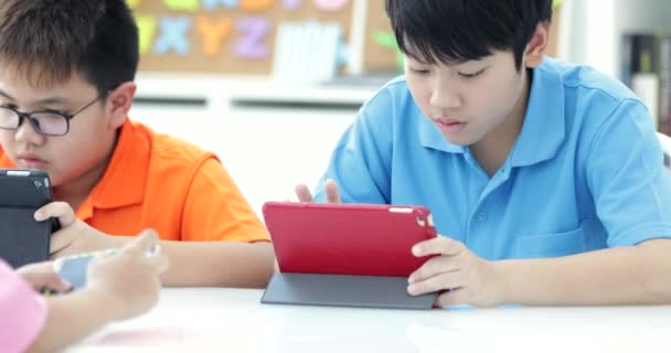 Asian Child Playing Tablet Computer Together — Stock Video