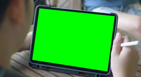 Tablet computer with green screen.