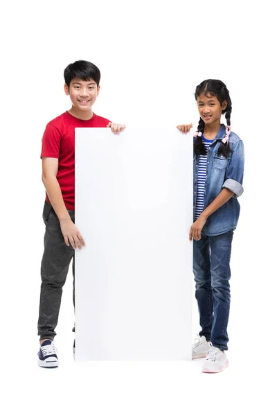 Asian child holds blank sign. Teen boy  and girl holds empty bil — Stock Photo, Image