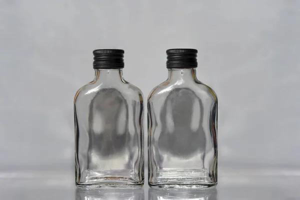 Two Empty Liquor Alcohol Glass Russian Vodka Bottles Black Caps — Stock Photo, Image