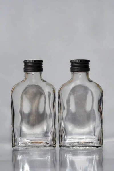 Two Empty Liquor Alcohol Glass Russian Vodka Bottles Black Caps — Stock Photo, Image