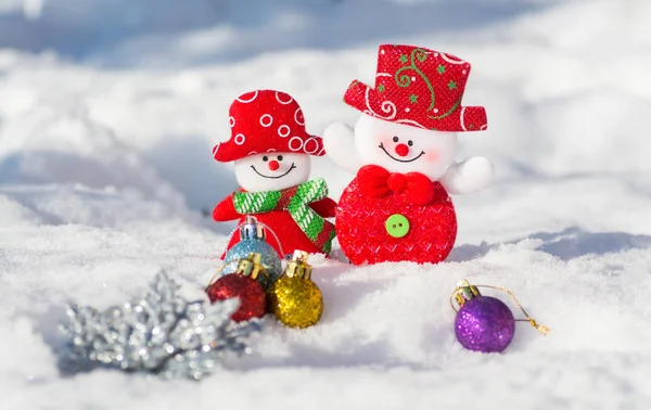 雪だるま少年と少女のクリスマスのおもちゃのクリスマス カード 雪とクリスマスのおもちゃの背景に笑顔の雪だるまのペア 幸福な新年とクリスマス — ストック写真