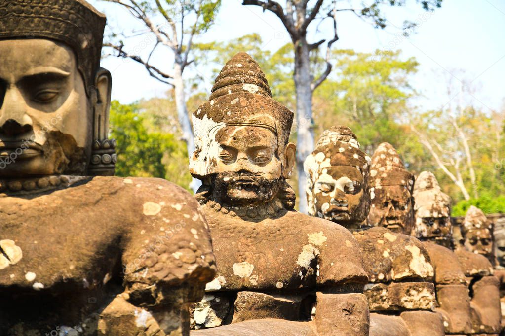 South gate to angkor thom in Cambodia is lined with warriors and demons