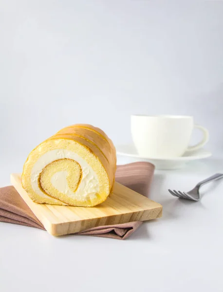 Swiss roll and coffee on white background. — Stock Photo, Image