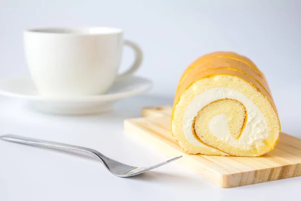 Swiss roll and coffee on white background. — Stock Photo, Image