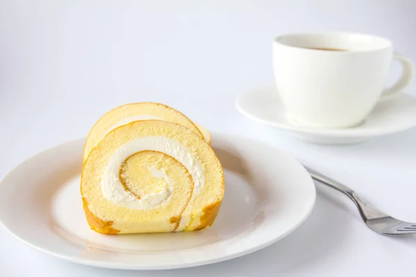 Swiss roll and coffee on white background. — Stock Photo, Image