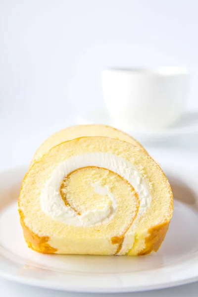 Swiss roll and coffee on white background. — Stock Photo, Image