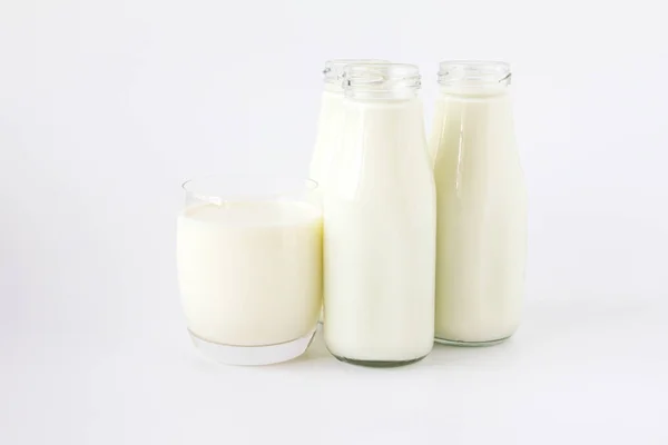 Bottle of milk and glass of milk on a white background — Stock Photo, Image