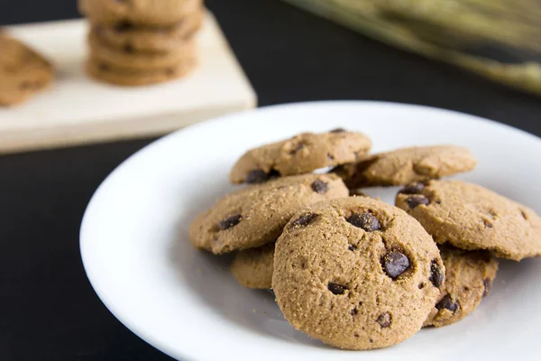 Chocolate Chip Cookies Doğrama ahşap ve beyaz plaka üzerinde