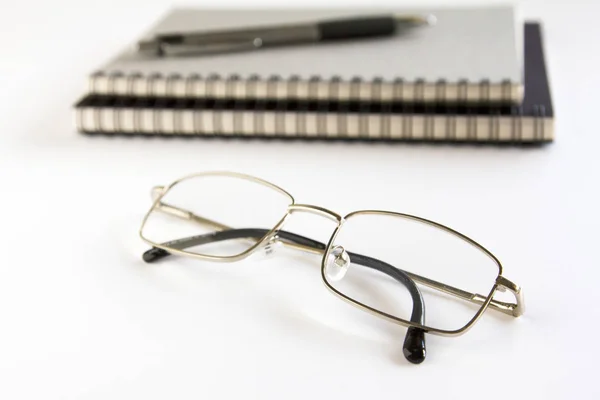Glasses ,notebook  and pen on white background. Stock Photo