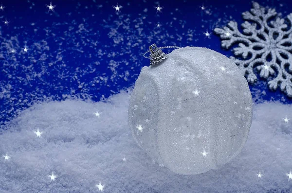 Ano Novo e cartão de Natal em um fundo azul clássico com uma bola de Natal branca na neve e com flocos de neve com espaço de cópia. Ano Novo Chinês . — Fotografia de Stock