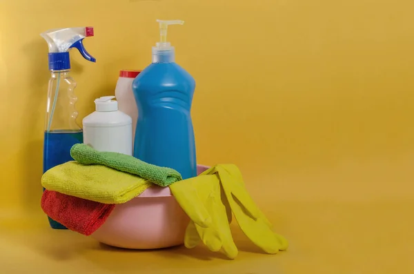 Household cleaning products with colorful napkins on a yellow background. Spring cleaning, the prevention of viral diseases. Cleaning in the house, in the apartment.