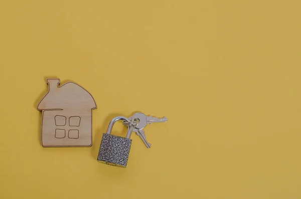 House with keys and a house lock, mortgage concept for real estate, moving or renting real estate. For realtors and realtor offices. Buying a house, apartment.