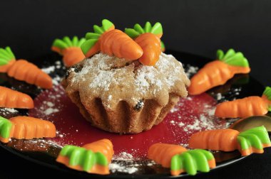 carrot cake decorated with carrots on a dark background. Carrot cake holiday. National carrot cake day.The view from the top