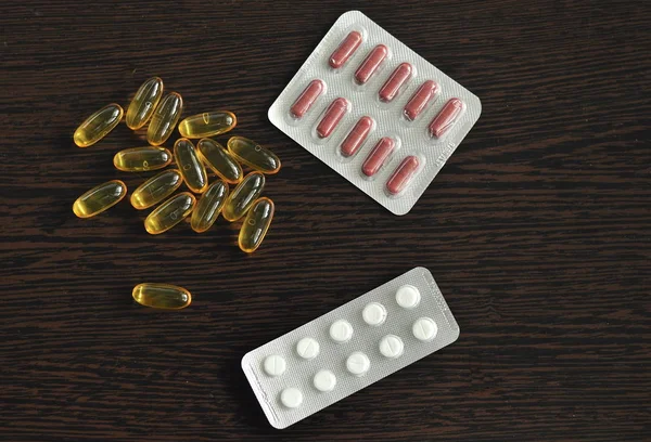 Medicine tablets are placed on a wooden background . Viruses, Medicine